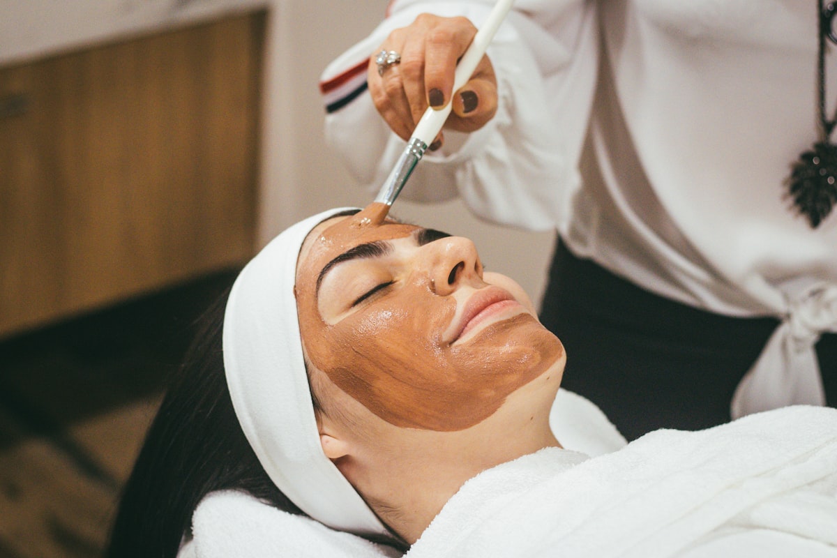 A woman receiving a facial treatment at a salon